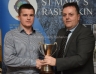 Antrim Chairman Collie Donnelly presents Declan McKay with the Antrim Junior Hurling Championship.